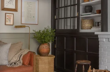 A living room corner with a sofa and artwork