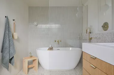 wet room bathroom with standalone tub and shower